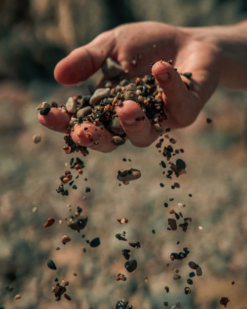 Free Dramatic capture of stones falling from a hand, outdoors in Dublin. Stock Photo