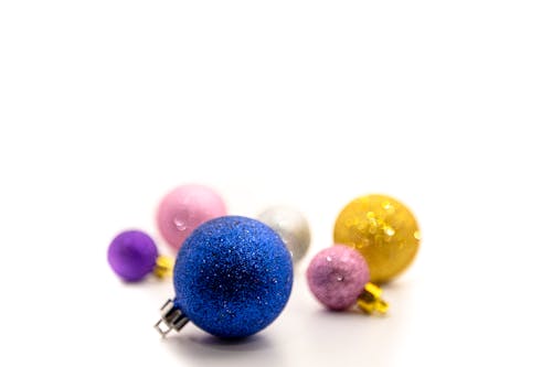 Shiny multicolored baubles on white background