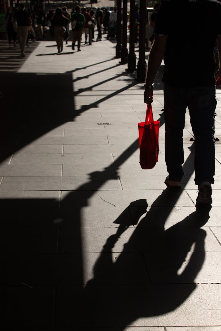 Anonymous Man Walking Along Sidewalk