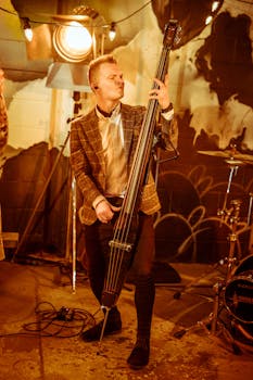 A lively musician playing an upright bass in an indoor music studio setting.