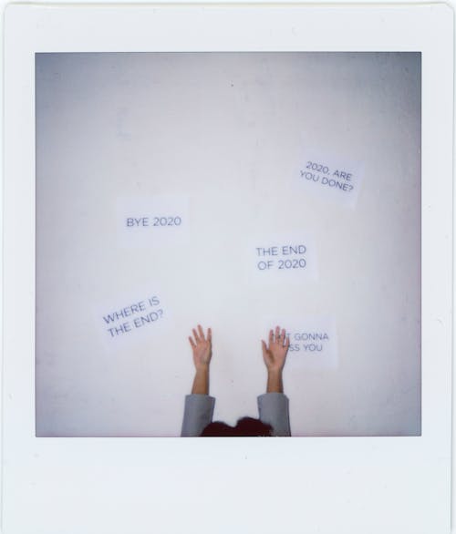 A Polaroid Photo of a Person Raising Hands