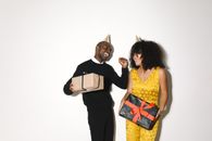 Man in Black Vest Standing Beside Woman in Yellow Sleeveless Dress