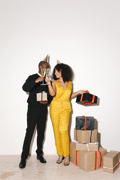 Couple Standing Near Gifts Toasting Champagne Glasses