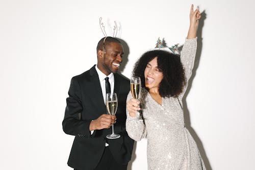 Couple Wearing Party Dress Holding Champagne Glasses