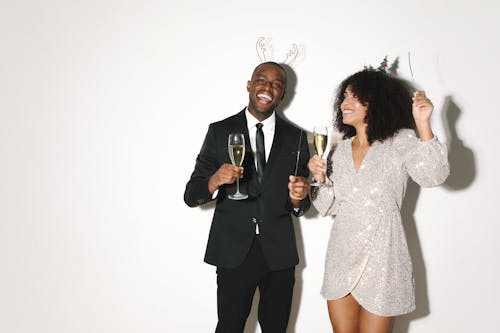 A Man and Woman Holding a Glass of Beverage 