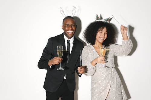 A Man and Woman Holding a Glass of Beverage 