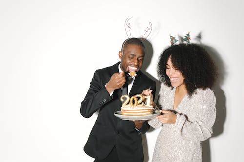 A Man and Woman Holding Cake