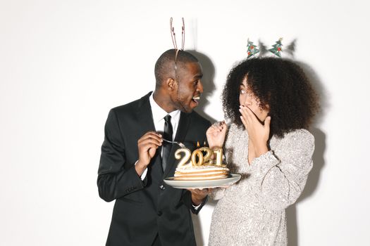 Man in Black Suit Kissing Woman in White Long Sleeve Shirt
