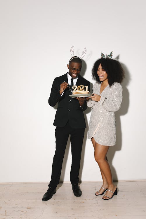 A Man and Woman Holding Cake