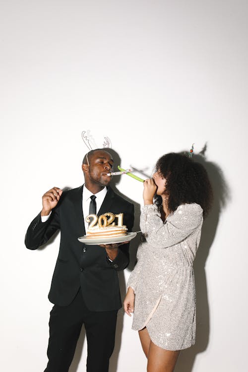 A Man and Woman Holding Cake