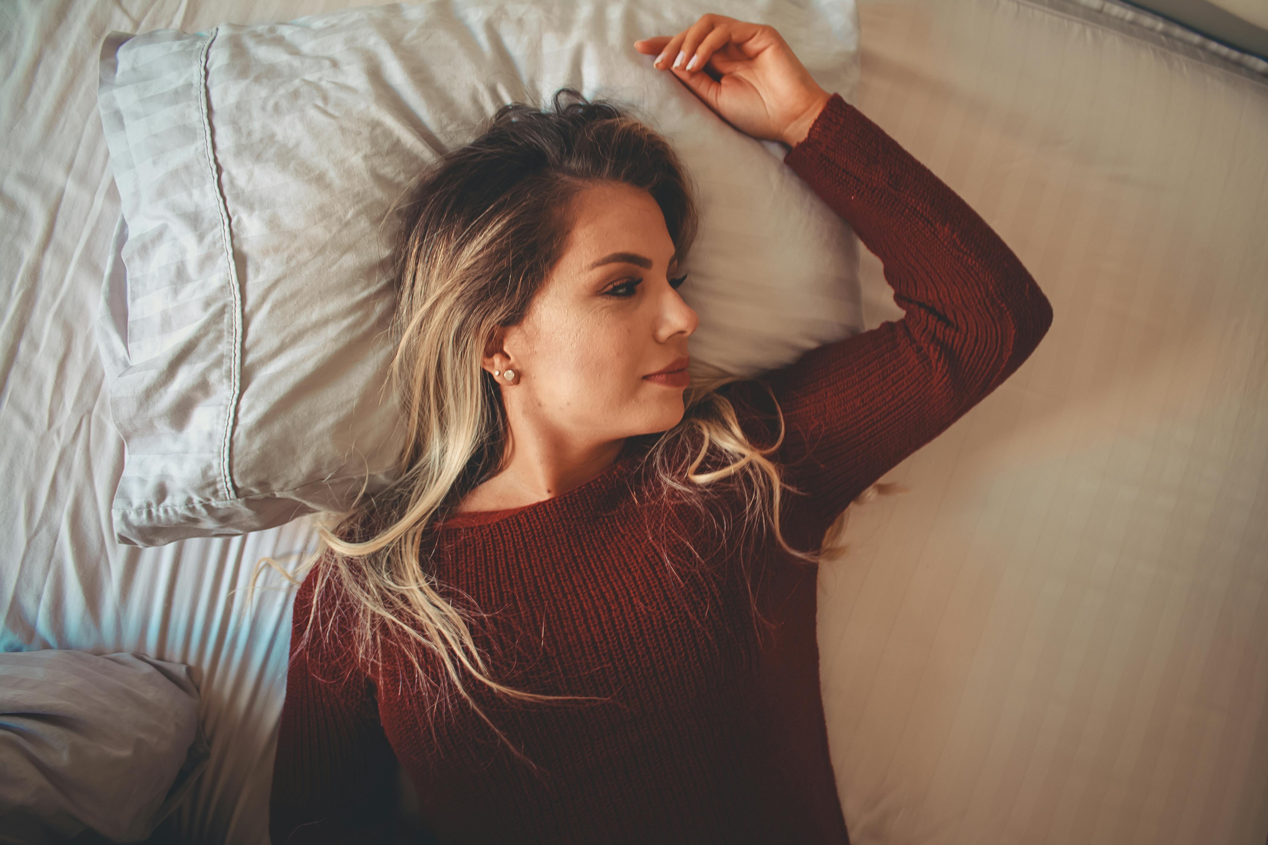 Blonde Woman Lying Face Down on a Couch · Free Stock Photo