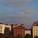 Red and White Concrete Buildings Under Gray Sky