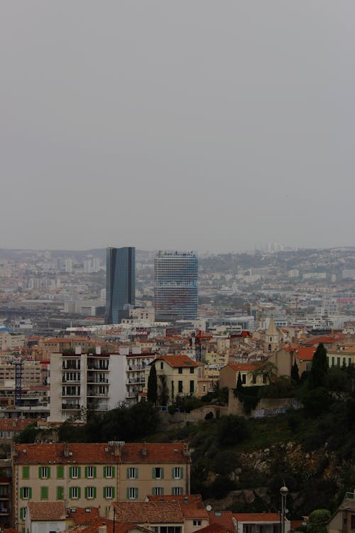 City With High Rise Buildings Under White Sky