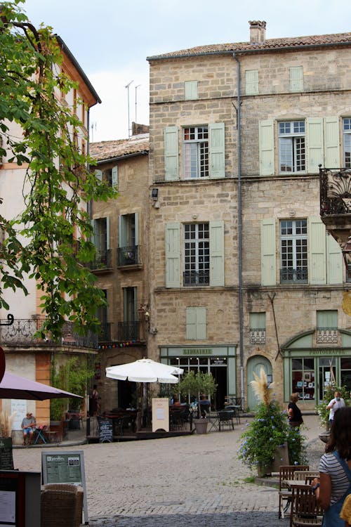 Building with Brick Walls Near the Cobblestone Street