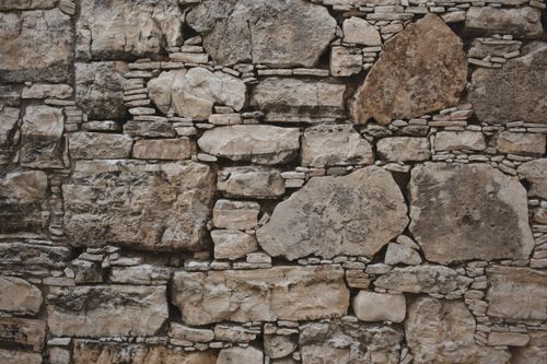 Free Close-up of a rustic stone wall showcasing unique textures and patterns, ideal for backgrounds. Stock Photo