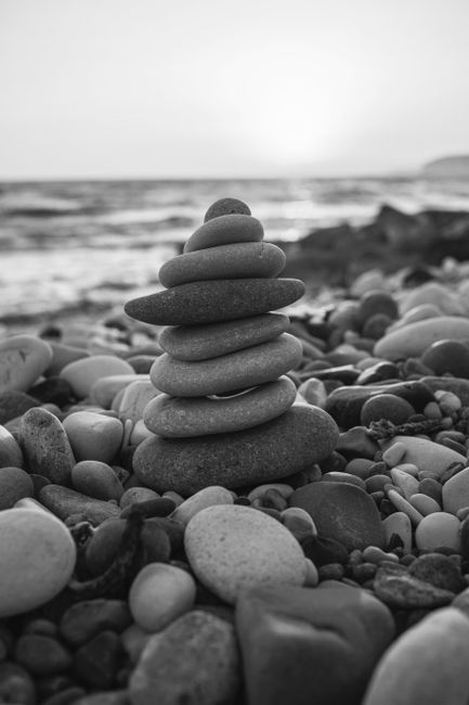 Peaceful rock balancing on a Cyprus beach at sunset. Serene coastal landscape perfect for relaxation and mindfulness.