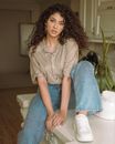Woman Sitting on Wooden Table Putting Her Foot Up