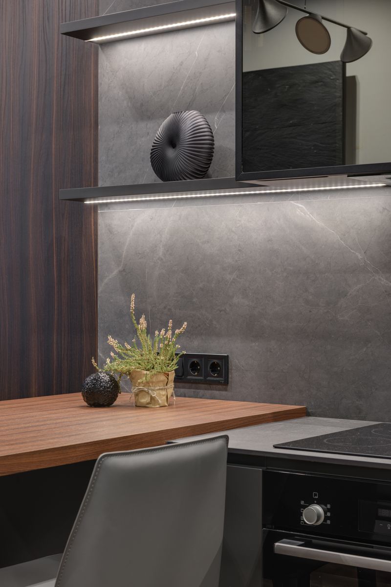 Interior of a compact kitchen in an apartment with minimalist design, wooden countertop, and modern fittings