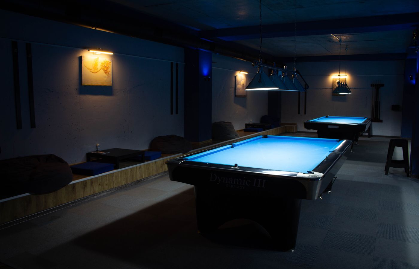 Inviting billiard hall interior with modern lighting and billiard tables, perfect for recreation.