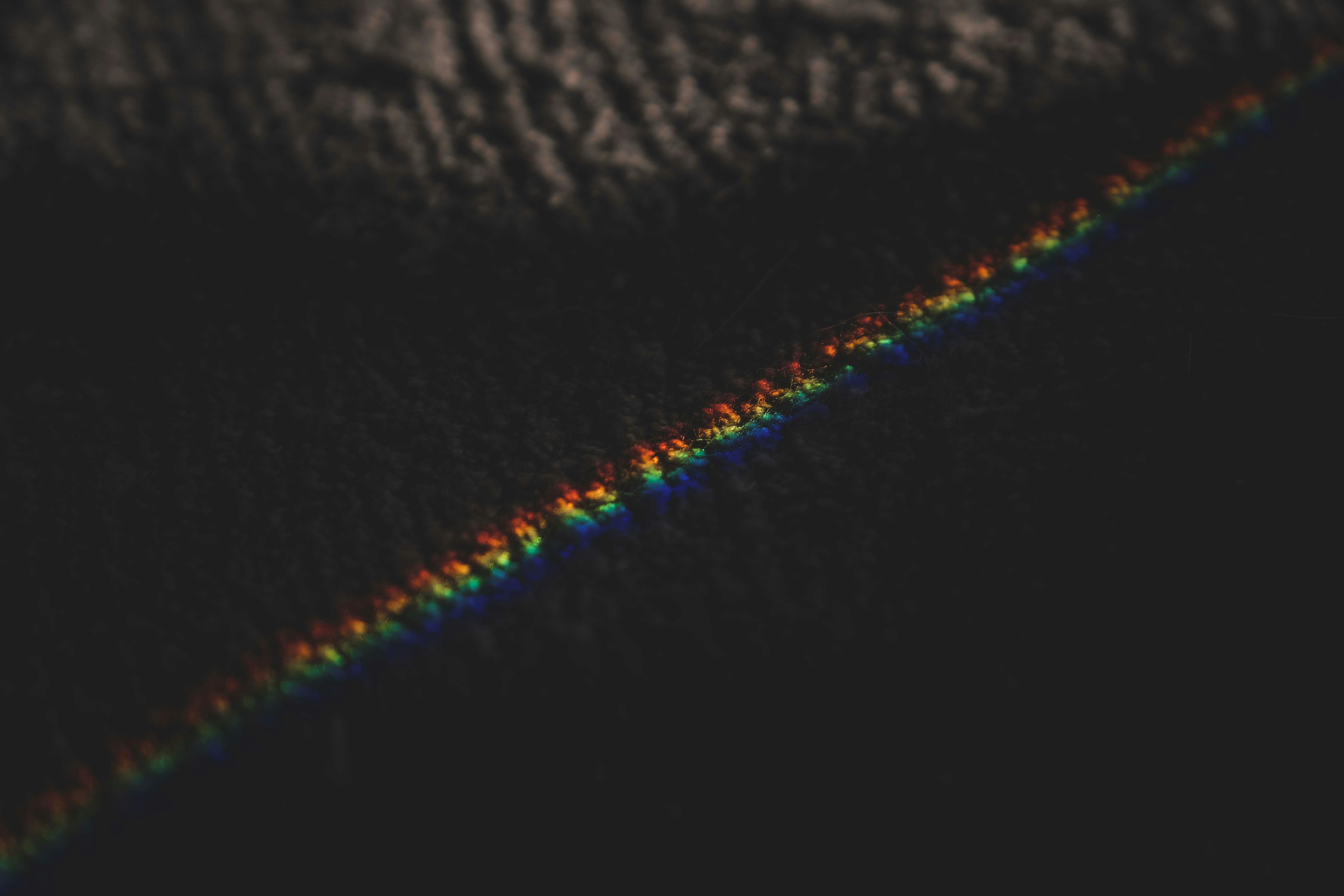 Rainbow stripes of prism light on carpet · Free Stock Photo