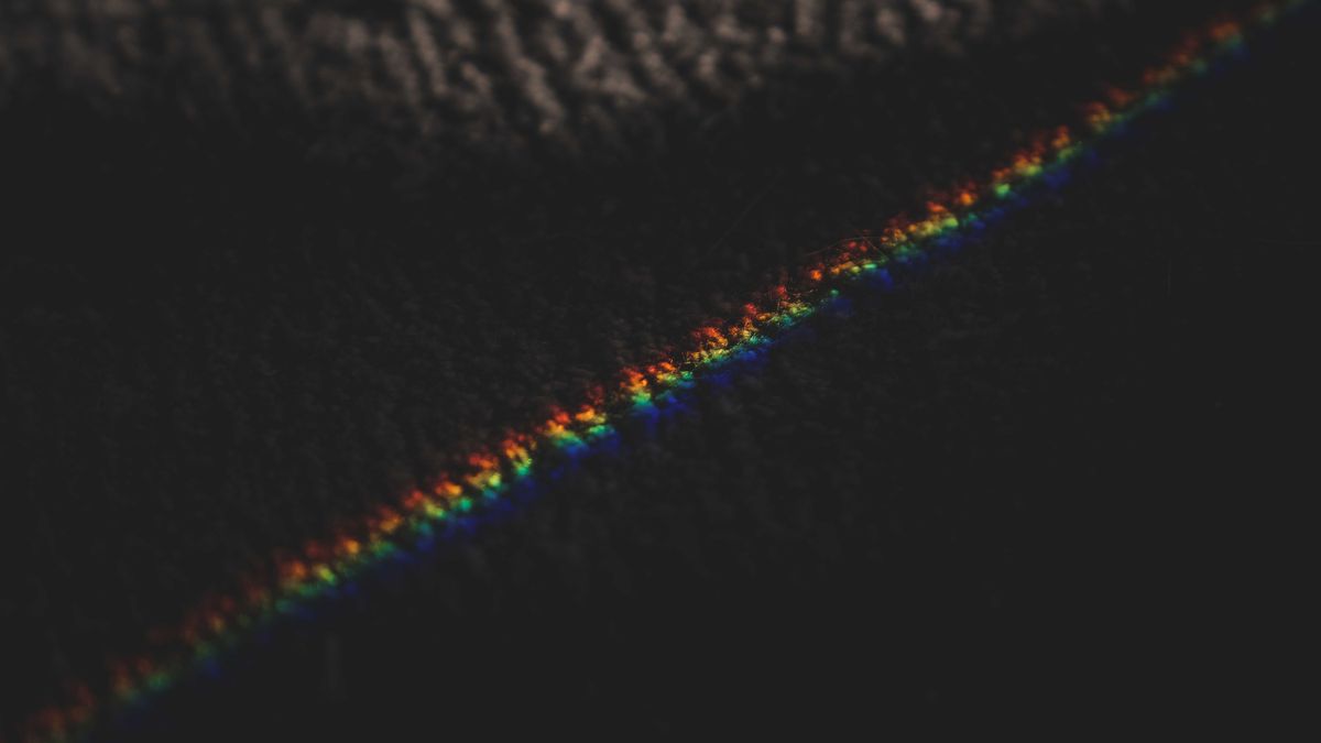 Photo: Francesco Ungaro / Pexels A band of rainbow light across a dark surface