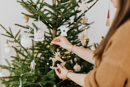 Free Person Holding White Christmas Tree Ornament Stock Photo