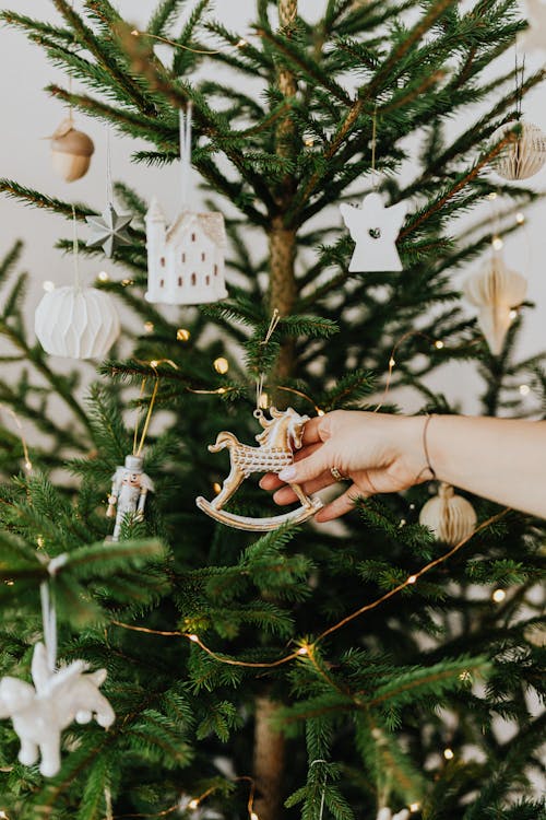 Free Person Holding Rocking Horse Christmas Tree Ornament Stock Photo