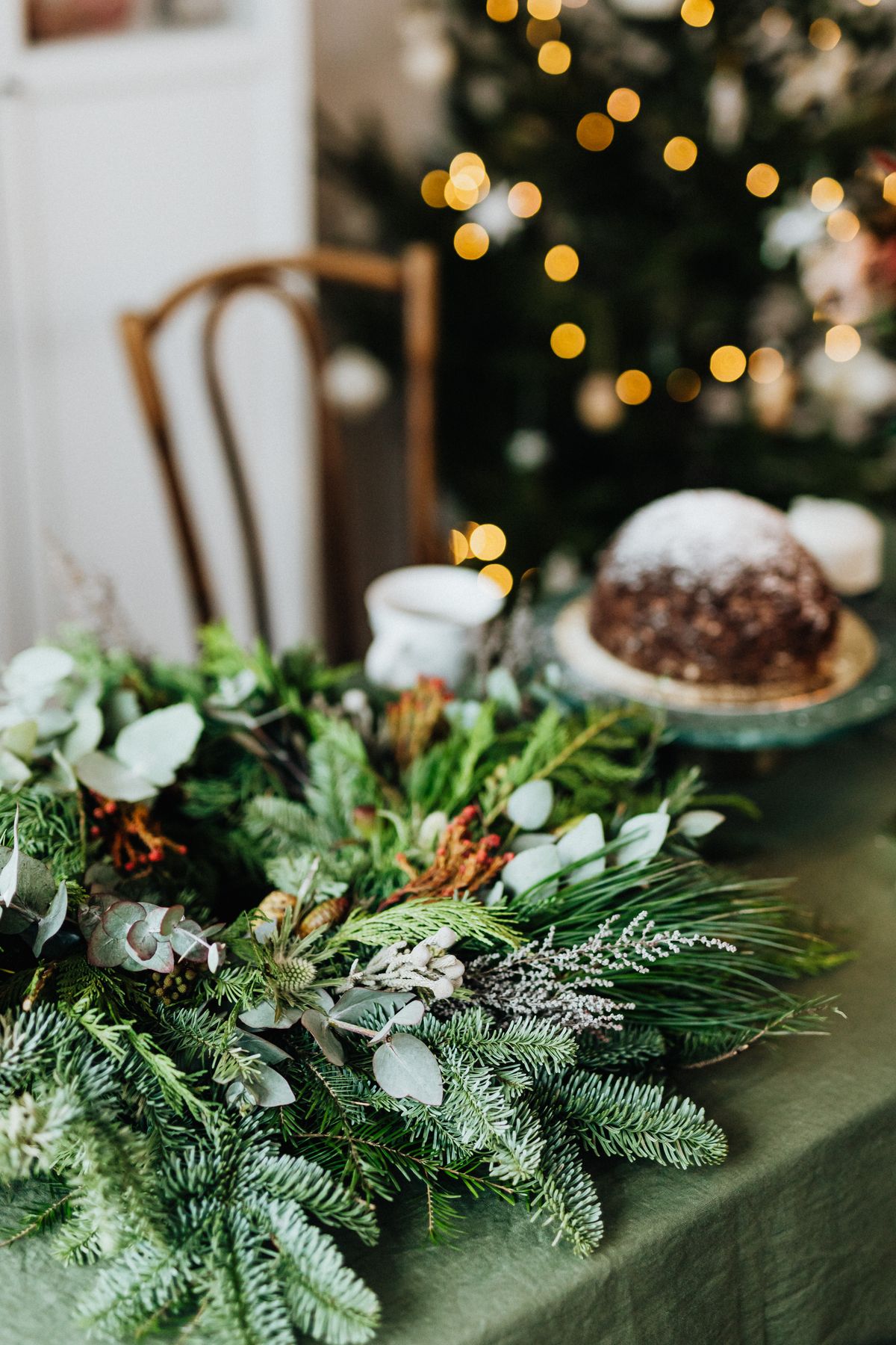 One low greenery centerpiece on a Christmas table