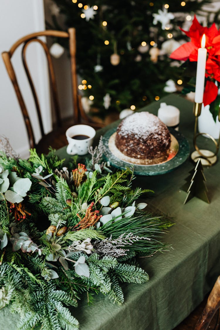 Christmas Wreath And Cake On A Table