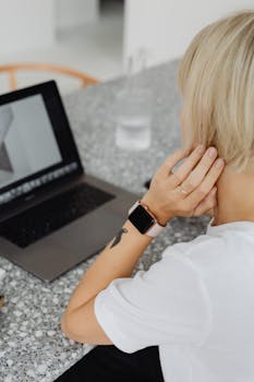 Woman working remotely on a laptop at home, emphasizing digital nomad lifestyle and technology.