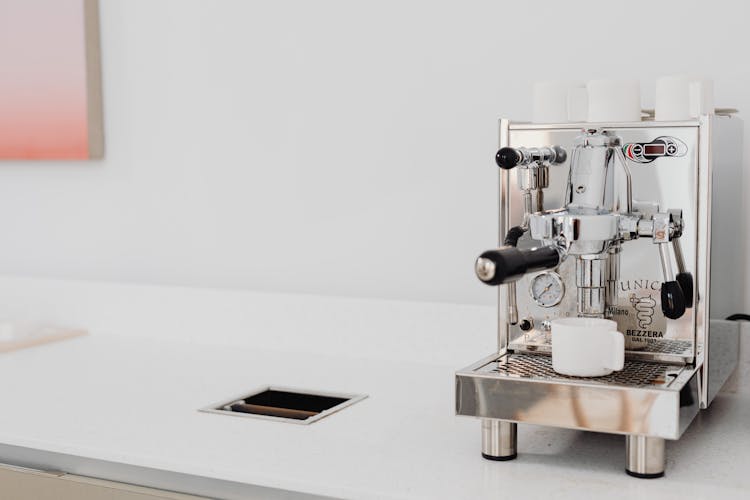 A Stainless Steel Industrial Espresso Machine With Mugs