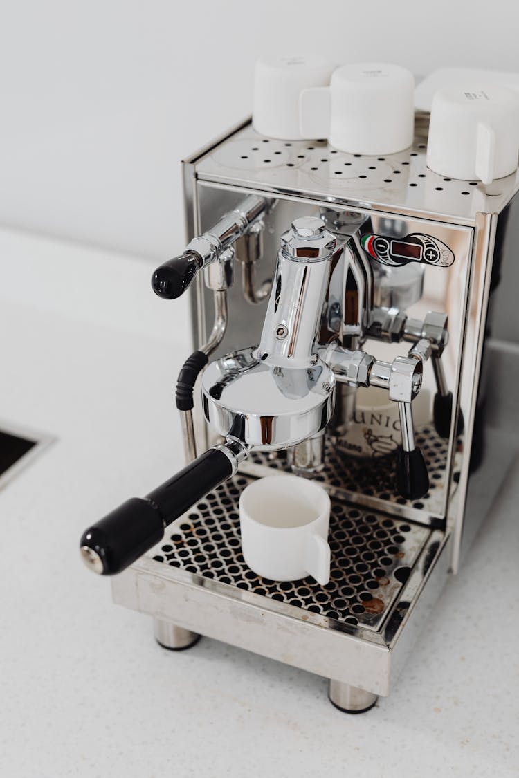 A Stainless Steel Industrial Espresso Machine With White  Mugs