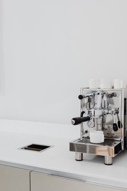 Elegant stainless steel espresso machine on a modern kitchen counter, ideal for coffee enthusiasts.