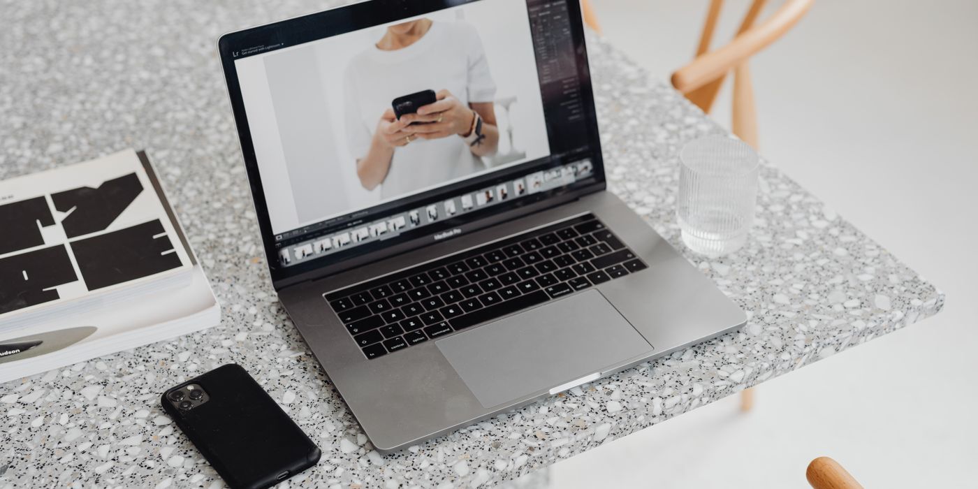 A laptop and smartphone showing an all-in hotel price during booking