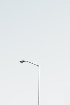Top of modern electric street lamp on street against clear cloudless sky