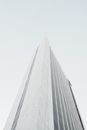 Facade of contemporary skyscraper against sky