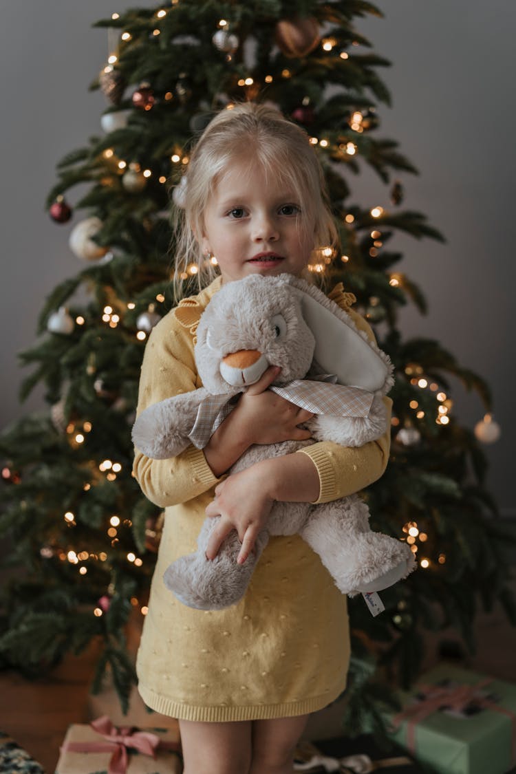 A Girl Hugging A Stuffed Animal