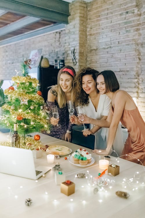 Free Three Women Holding Glasses Of Wine At A Zoom Party  Stock Photo