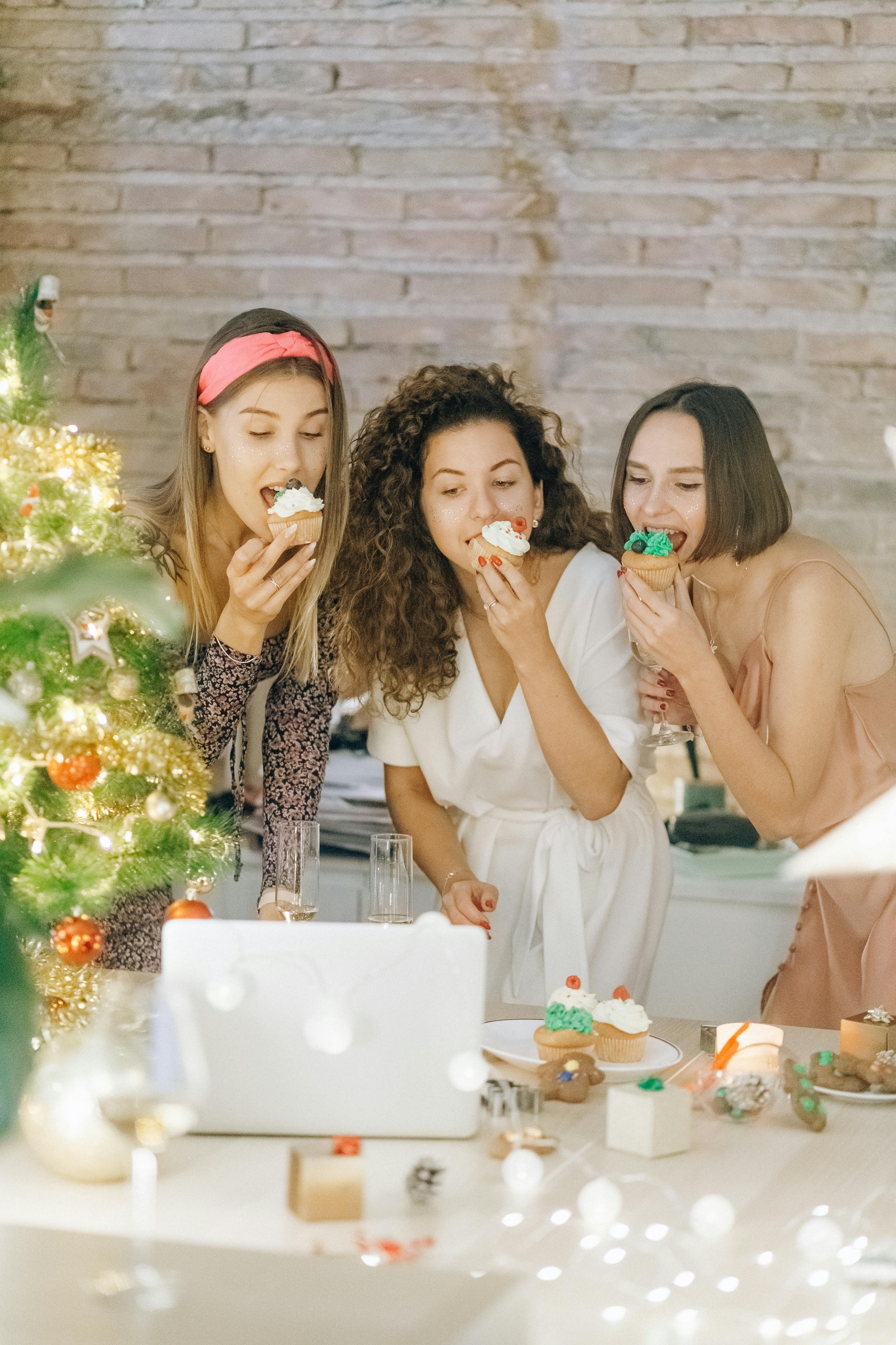 three women eating ice cream while having a video chat