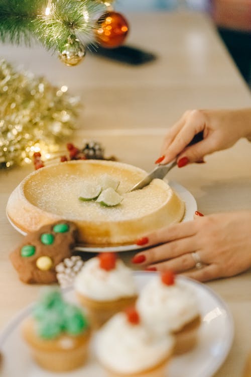 Free A Person Slicing Baked Cake Stock Photo