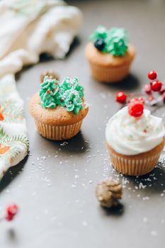 Close-up of festive cupcakes with holiday-themed decorations and vibrant frosting.