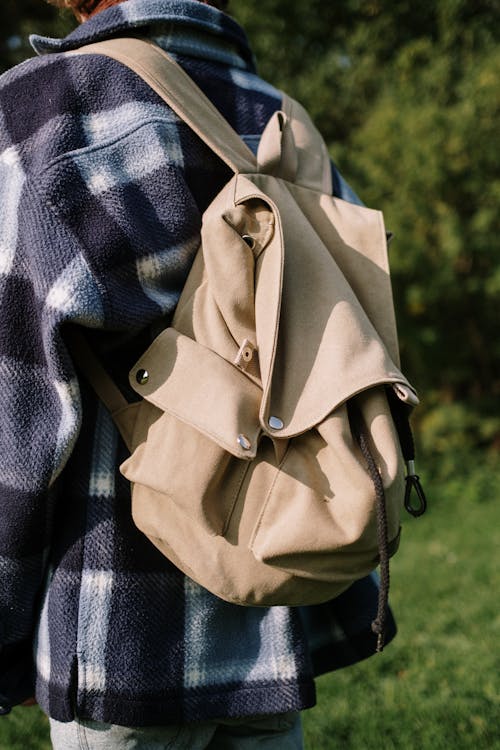 Close-Up of a Person in Plaid Jacket Carrying a Backpack
