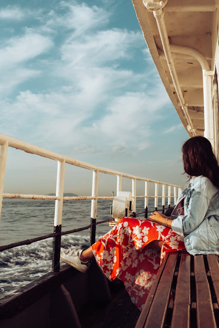 Person Wearing Denim Jacket And Red Floral Dress