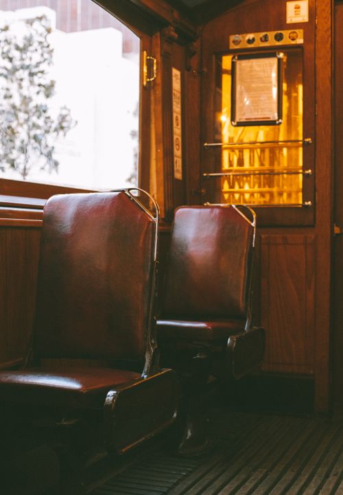 Free Cozy vintage tram interior featuring brown leather seats and wooden accents in Istanbul. Stock Photo