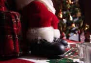 Black Remote Control Beside Red and White Santa Hat