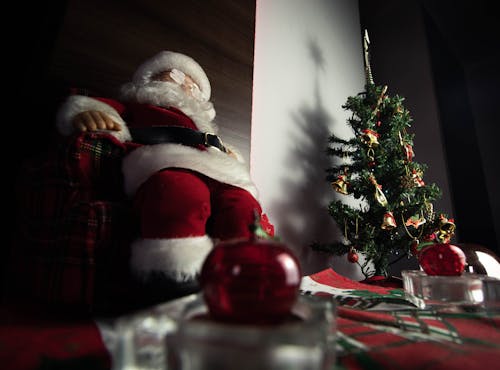 Santa Claus Figurine Beside the Christmas Tree