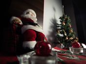 Santa Claus Figurine Beside Red Baubles