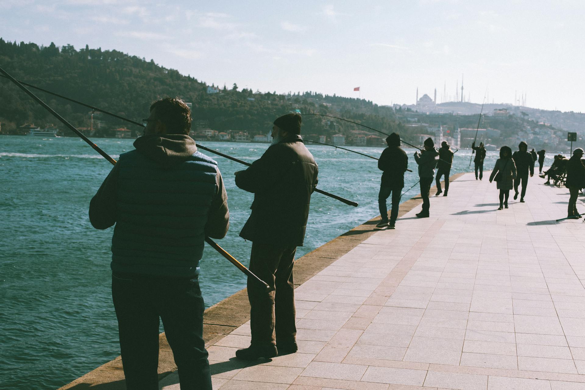 Group of people fishing at the Bosphorus Strait in Istanbul, Turkey.
