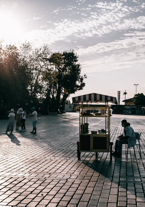 A Vendor Selling Food Using a Cart on the Street