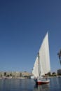 White Sail Boat on Sea Under a Blue Sky
